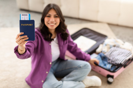 Woman holding passport ready to travel, home interiorの写真素材