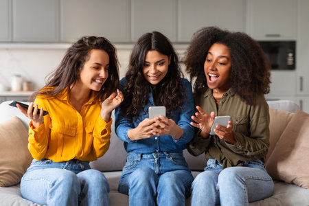 Group of friends looking at smartphone at homeの写真素材