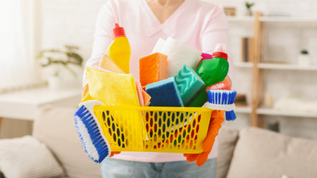 Woman Holding a Basket Full of Cleaning Supplies Croppedの写真素材