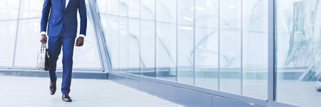 Unrecognizable African American Businessman Walking With Briefcase In Cityの写真素材