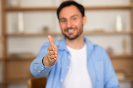 Selective focus on man hand outstretched towards cameraの写真素材