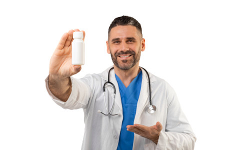Happy Doctor Showing a Medical Bottle in White Background Studioの写真素材