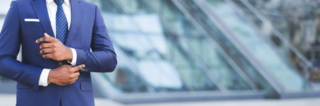 African American Businessman Adjusting Sleeve Cuff In City, Croppedの写真素材