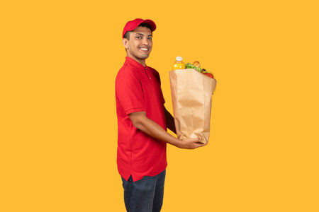 Delivery Man Holding Paper Bag Full of Foodの写真素材