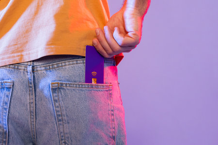 Cropped of Man Holding Purple Card in Pocket