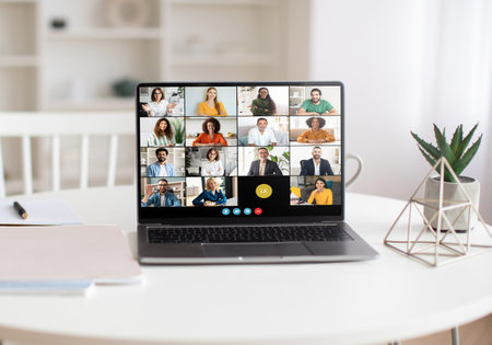 Virtual Team Meeting on Laptop in a Bright Home Office
