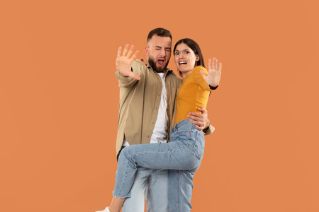 Displeased young couple make gesture say no reject refuse