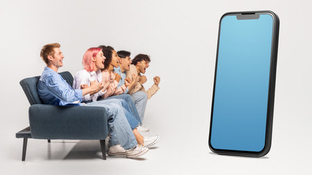 Multiracial group sitting on couch, looking at huge phone