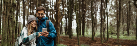 Couple Using Smartphone in a Forest During the Day