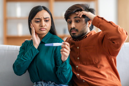 Worried Couple Holding Pregnancy Test on Living Room Couch