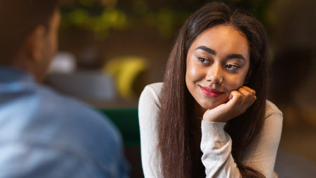 African American Girl Looking at Guy in Restaurantの写真素材