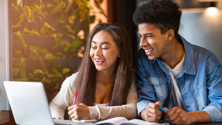 Young Guy and Girl Studying Together on Laptop in Cafe