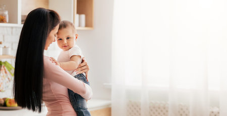 Woman Holding Baby in Arms, Panorama With Copy Space