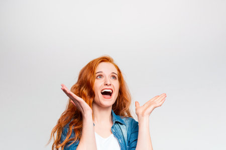 Excited Red-Haired Woman With Open Arms Reacting Joyfully