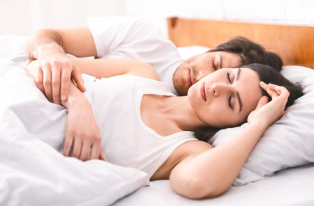 Woman Sleeping Peacefully While Partner Holds Her Close in Bed