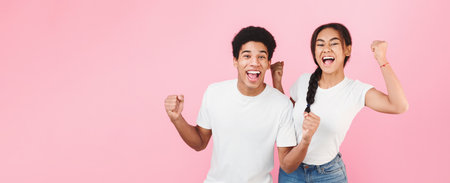 Success. African-american teens raising their hands happily