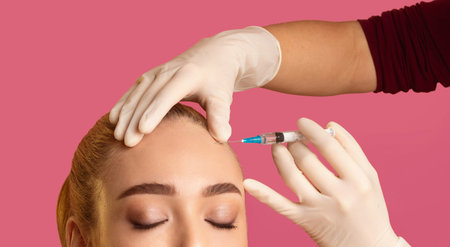 Woman Receiving Forehead Injection Against Pink Background