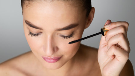 Doing Makeup. Woman Applying Mascara on Eyelashesの写真素材