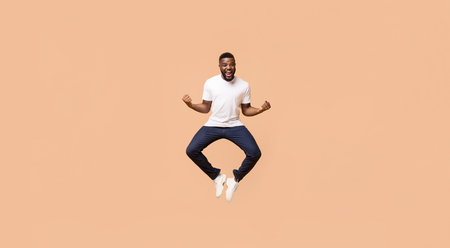Excited Man Jumping In Front Of A Peach Background, Gesturing