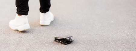 Man accidently dropped his leather wallet with moneyの写真素材