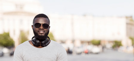 Man Wearing Headphones and Sunglasses in Cityの写真素材