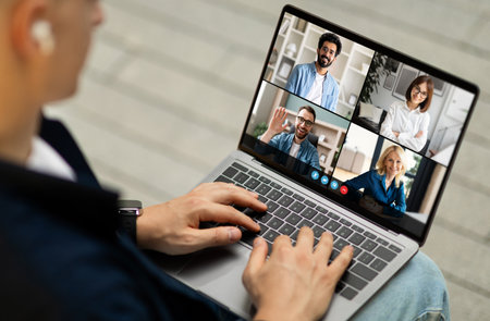 Man Participating in a Video Conference Meeting With Four Friends
