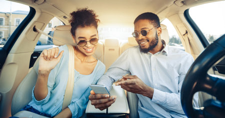 Happy Couple Using Smartphone While Riding In Car