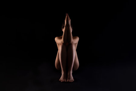 Woman Sitting in Yoga Pose With Hands in Prayer Positionの写真素材