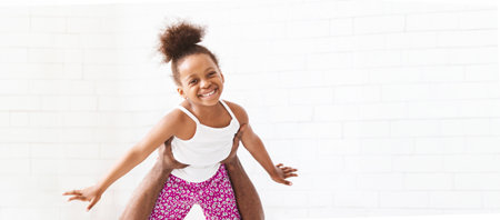 Happy Little Black Girl Flying Through The Airの写真素材