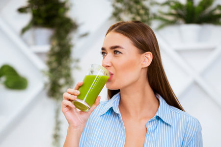 Woman Drinking Green Smoothieの写真素材