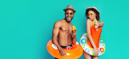 Happy African American Couple Posing With Inflatable Rings, Water Guns