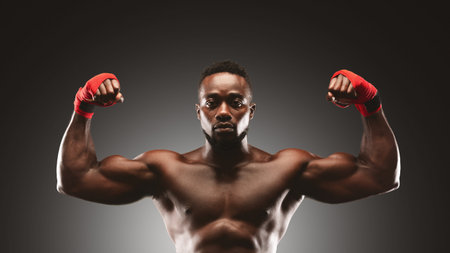Muscular Man Flexing Biceps in Studioの写真素材