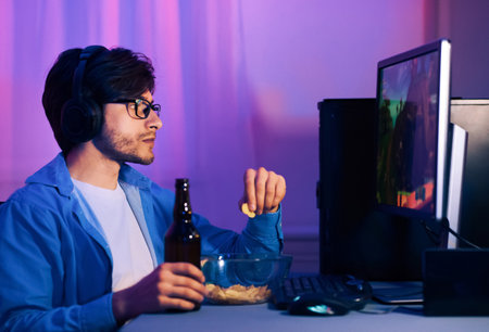 Gamer Enjoying Snacks And Drinks While Gamingの写真素材