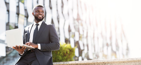 Cheerful Business Guy Working On Laptop During Coffee Break Outdoor