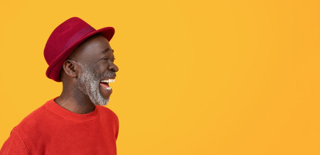 Side profile of a joyful black senior man laughing, dressed in a