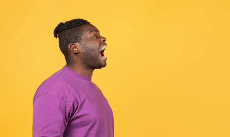 Side view of mad african american guy shouting looking asideの写真素材