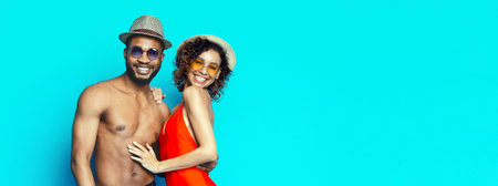 Happy Couple Wearing Sunglasses and Hats On Blue Background