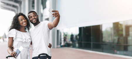 Happy Couple Taking a Selfie at Airport Departureの写真素材