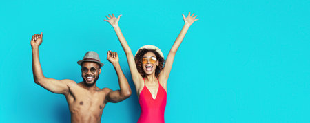 Happy Couple Celebrating Summer With Arms Raised in the Airの写真素材