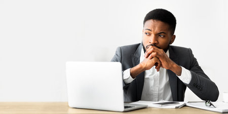 Thoughtful african entrepreneur getting nervous on workplaceの写真素材