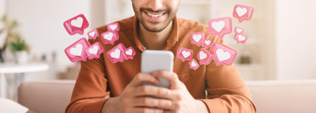 Man Smiling While Checking His Smartphone With Many Digital Heartsの写真素材