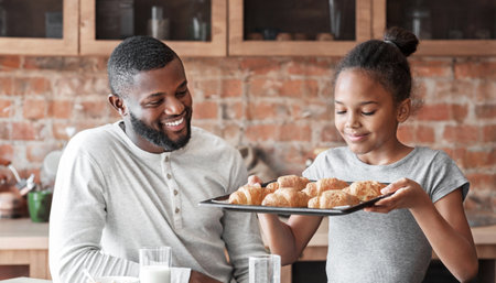 Cute girl holding tray with freshly baked croissantsの写真素材
