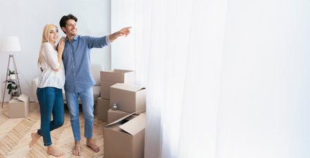 Couple Standing in New Home With Boxes