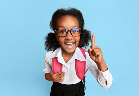 African School Girl Pointing Finger Up, Yellow Background, High-Angle Shotの写真素材