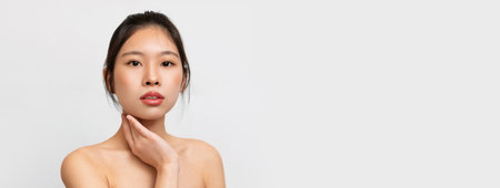 Beauty portrait of young Asian woman posing at cameraの写真素材