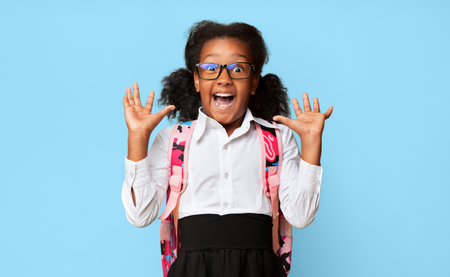 African American Elementary School Girl Shouting In Surprise, Studio Shotの写真素材