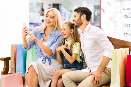 Happy Family Taking A Selfie After Shopping In A Mallの写真素材