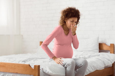 African-american expectant woman feeling nauseous, covering mouthの写真素材