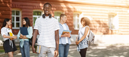 Education grants. Portrait of happy african student posing in university campus