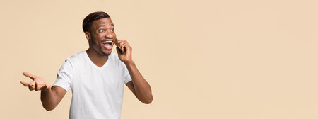 Excited African American Man Talking On Cellphone Standing, Studio Shot